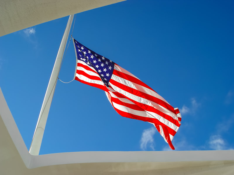 Flag flying over Pearl Harbor Memorial - Hawaii
